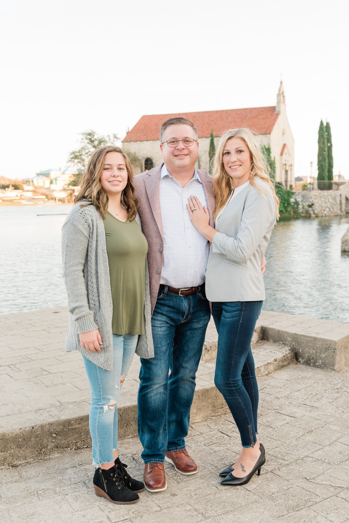 Jim Hemmingway, Christine Hemmingway, and their daughter posing for a family photo.